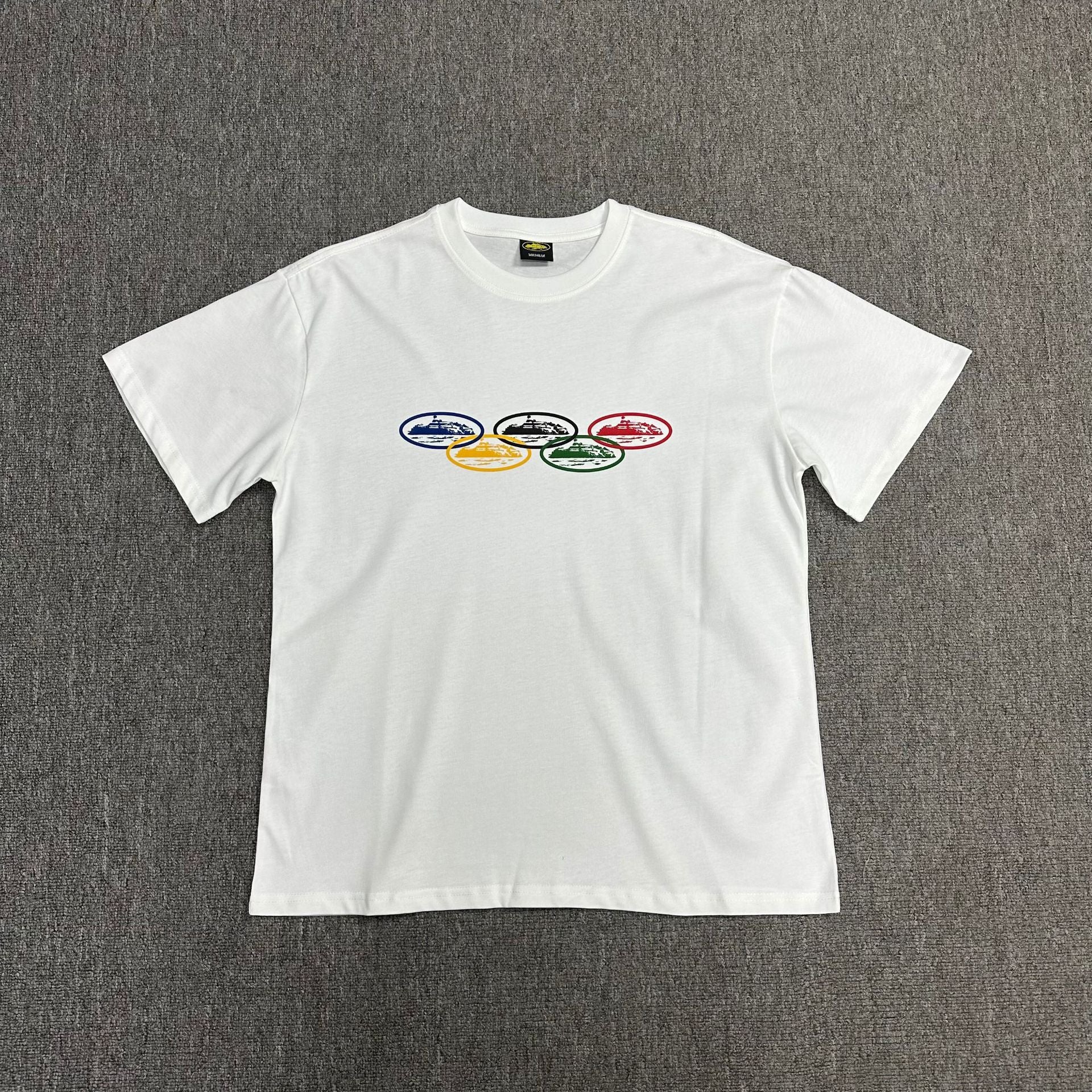 White t-shirt with colorful graphic on a gray background