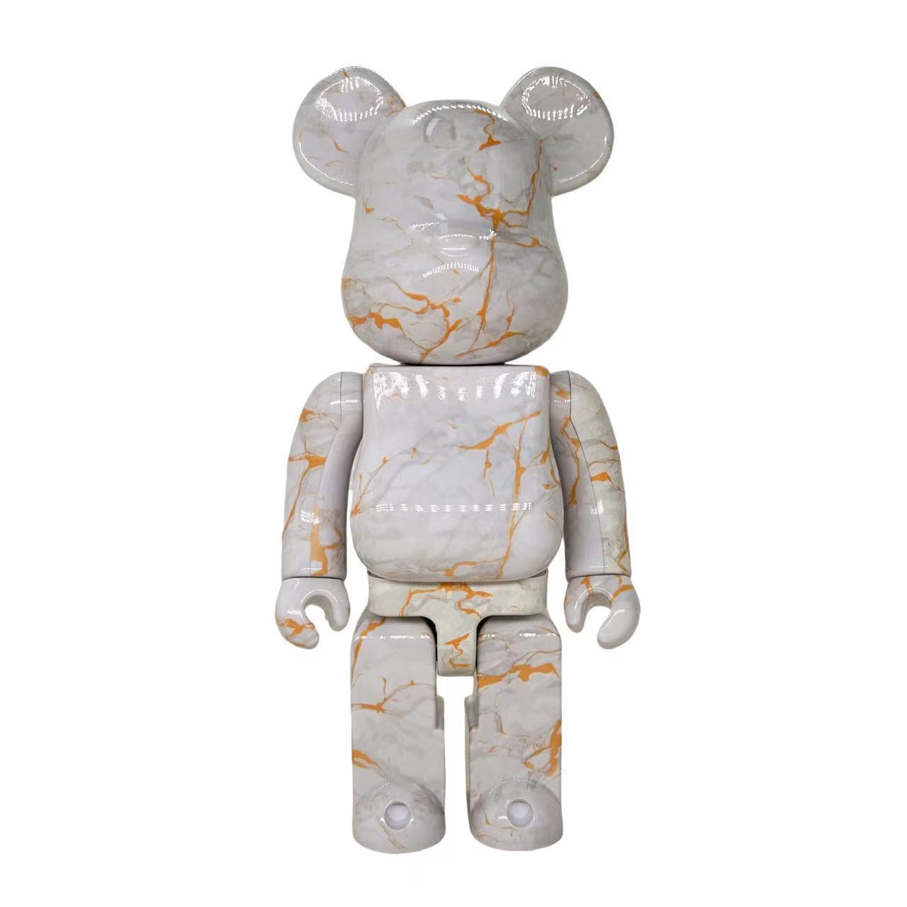 A bear-shaped collectible figure with a glossy white marble pattern accented by orange veins, shown against a plain white background.