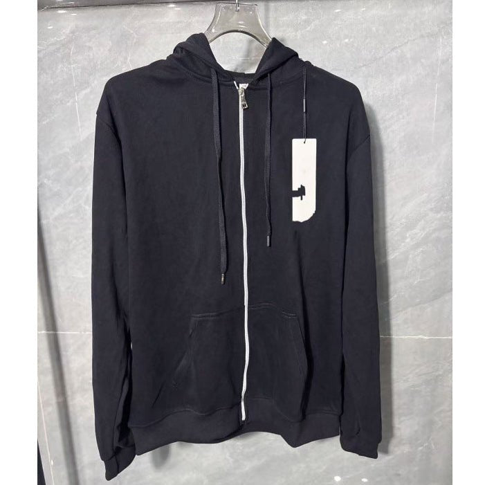 Black hoodie with a white logo tag on a gray background