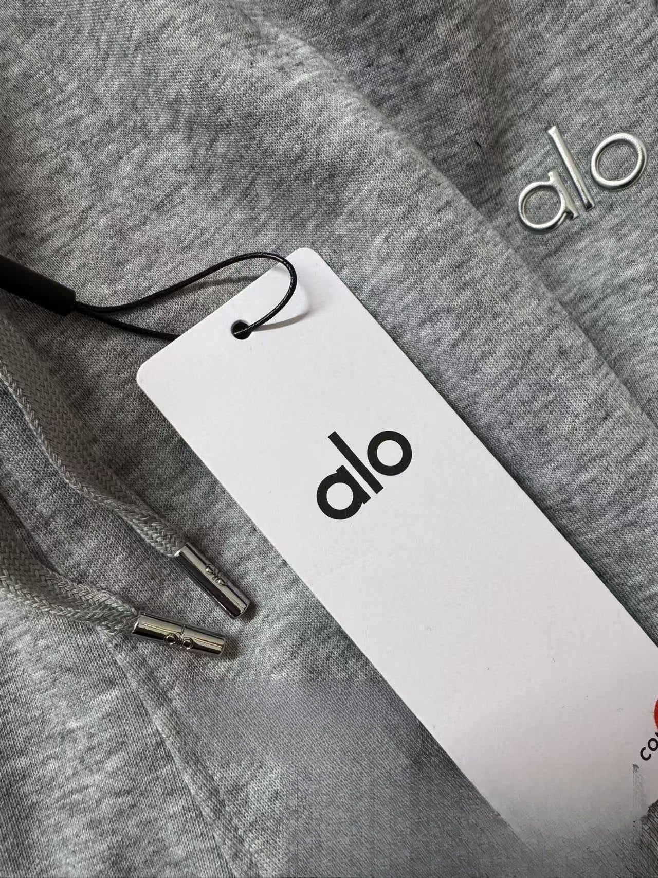 Gray fabric with a 'alo' tag on a gray background