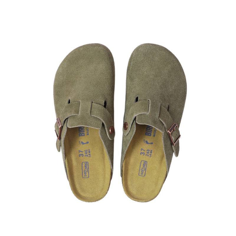 Pair of green suede shoes with buckles on a white background