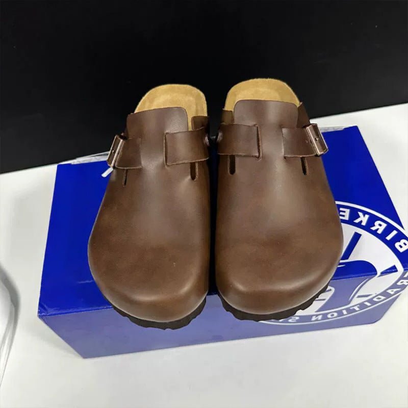 Pair of brown leather clogs on a Birkettion box.