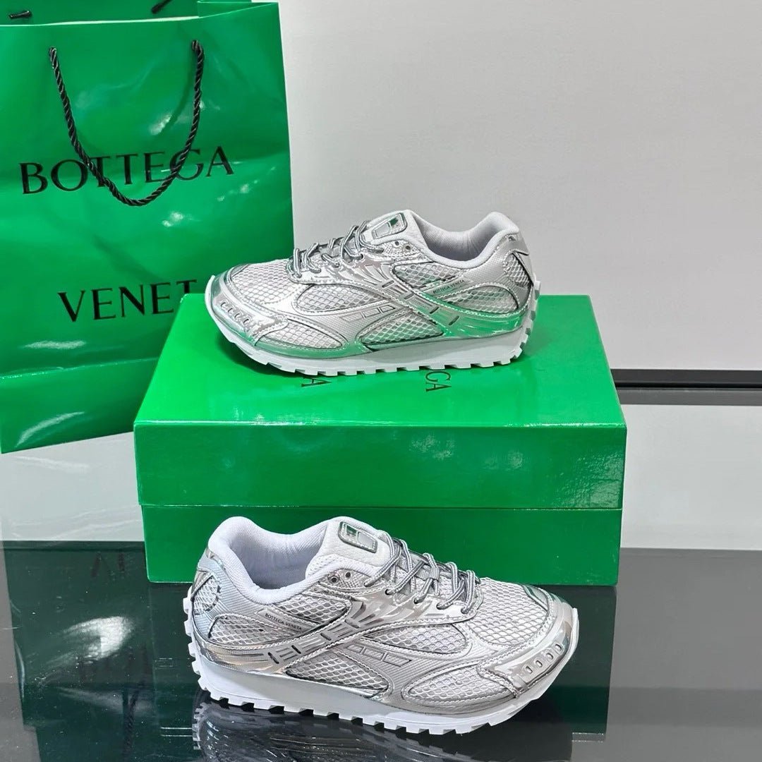White running shoes on a green box with a green 'Bottega Veneta' bag in the background.