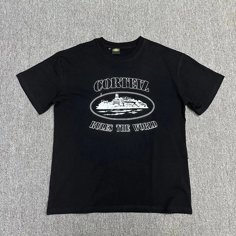 Black t-shirt with white graphic and text on a gray textured background