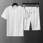 White t-shirt and shorts set on a dark background