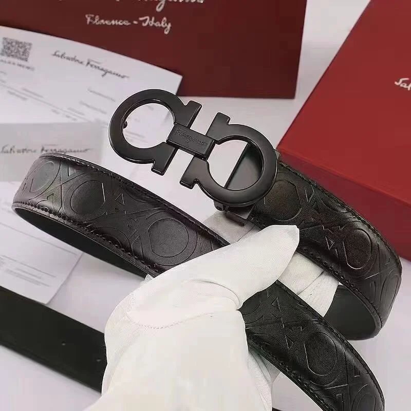 Black belt with a logo being held by a gloved hand on a white background