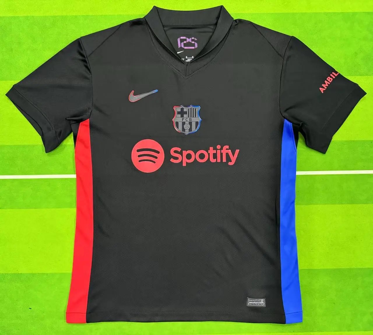 Black sports jersey with Nike, FC Barcelona, and Spotify logos on a green background