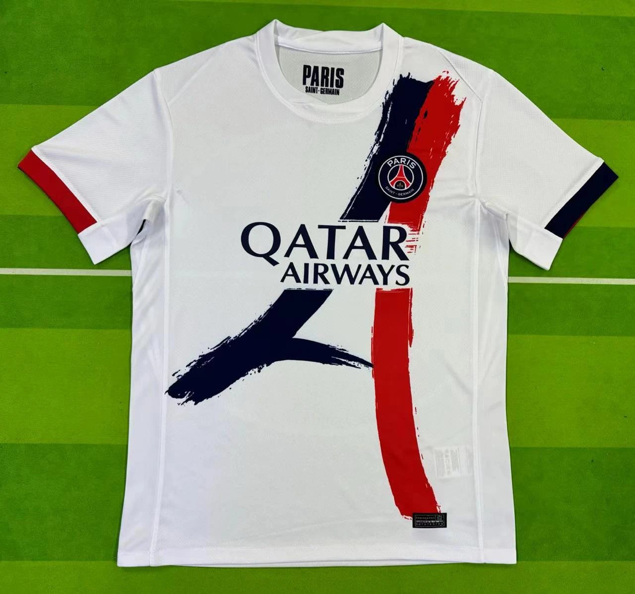 White sports jersey with Qatar Airways logo on a green field
