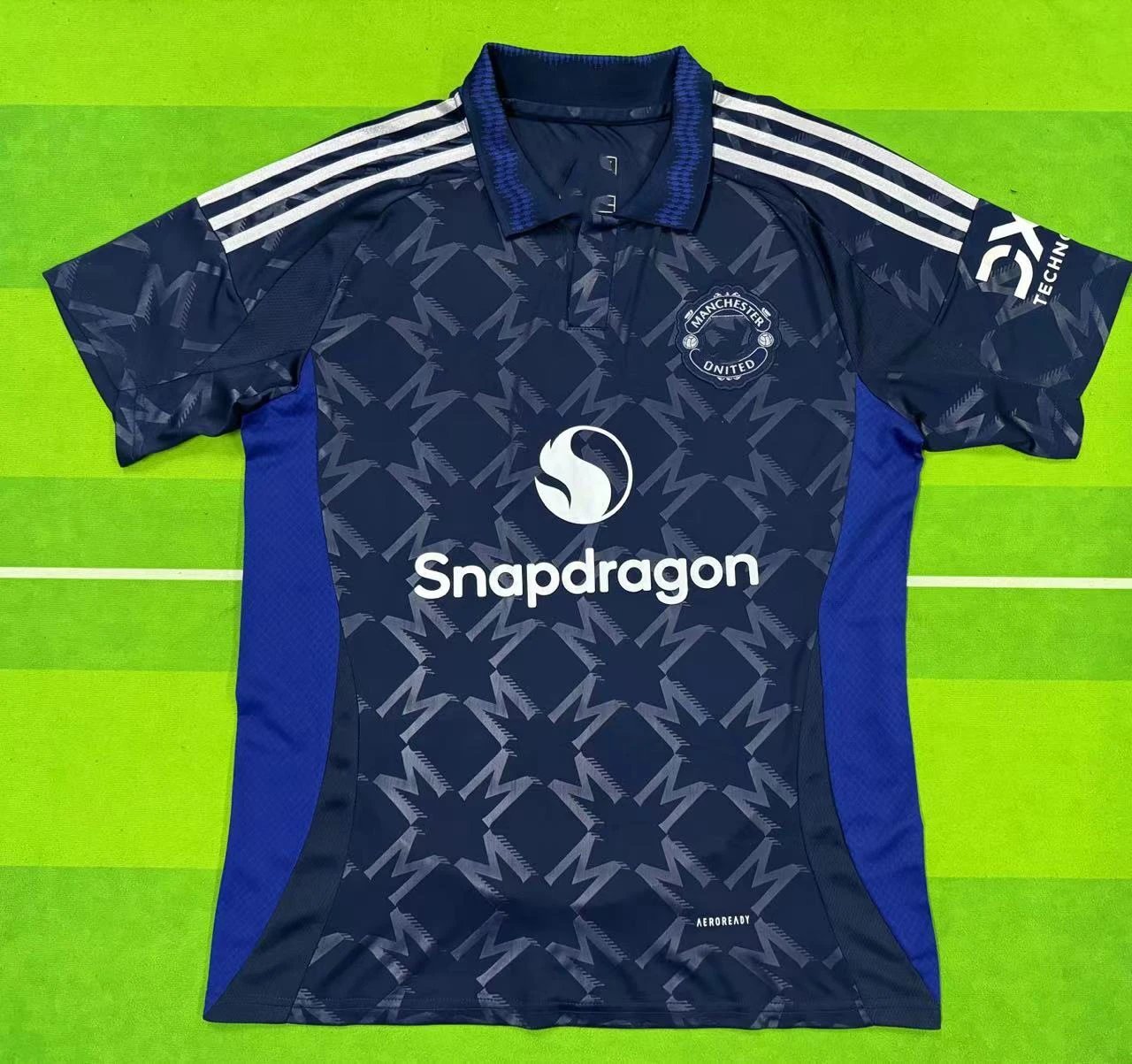 Navy sports jersey with blue sleeves on a green background