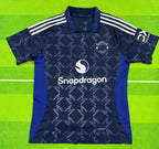 Navy sports jersey with blue sleeves on a green background