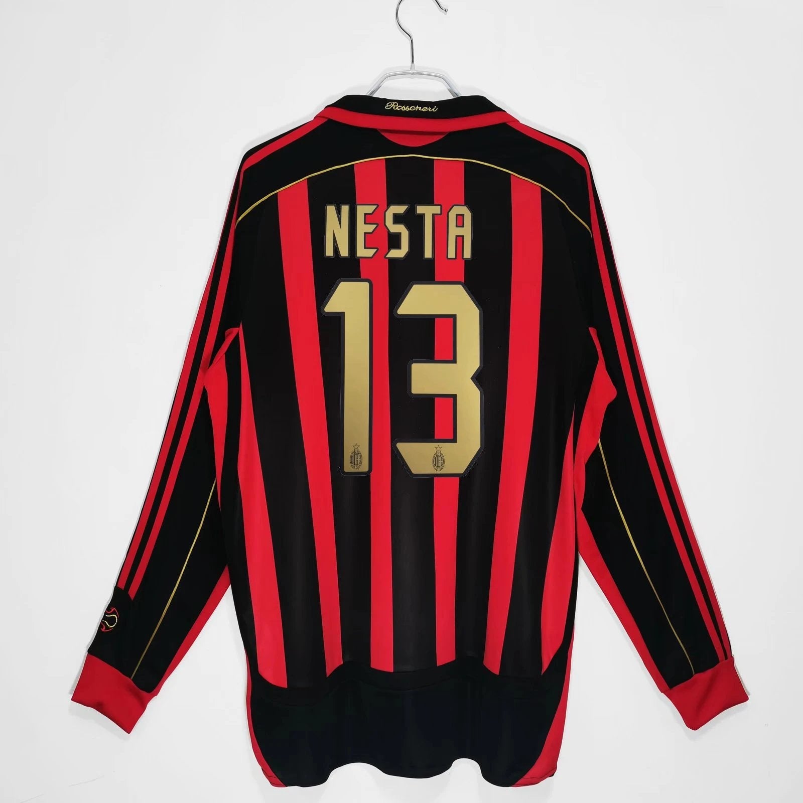 Black and red striped sports jersey with 'Nesta' and number '13' on a white background
