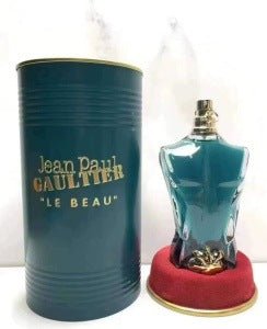 Blue perfume bottle and packaging with 'Jean Paul Gaultier Le Beau' text on a white background