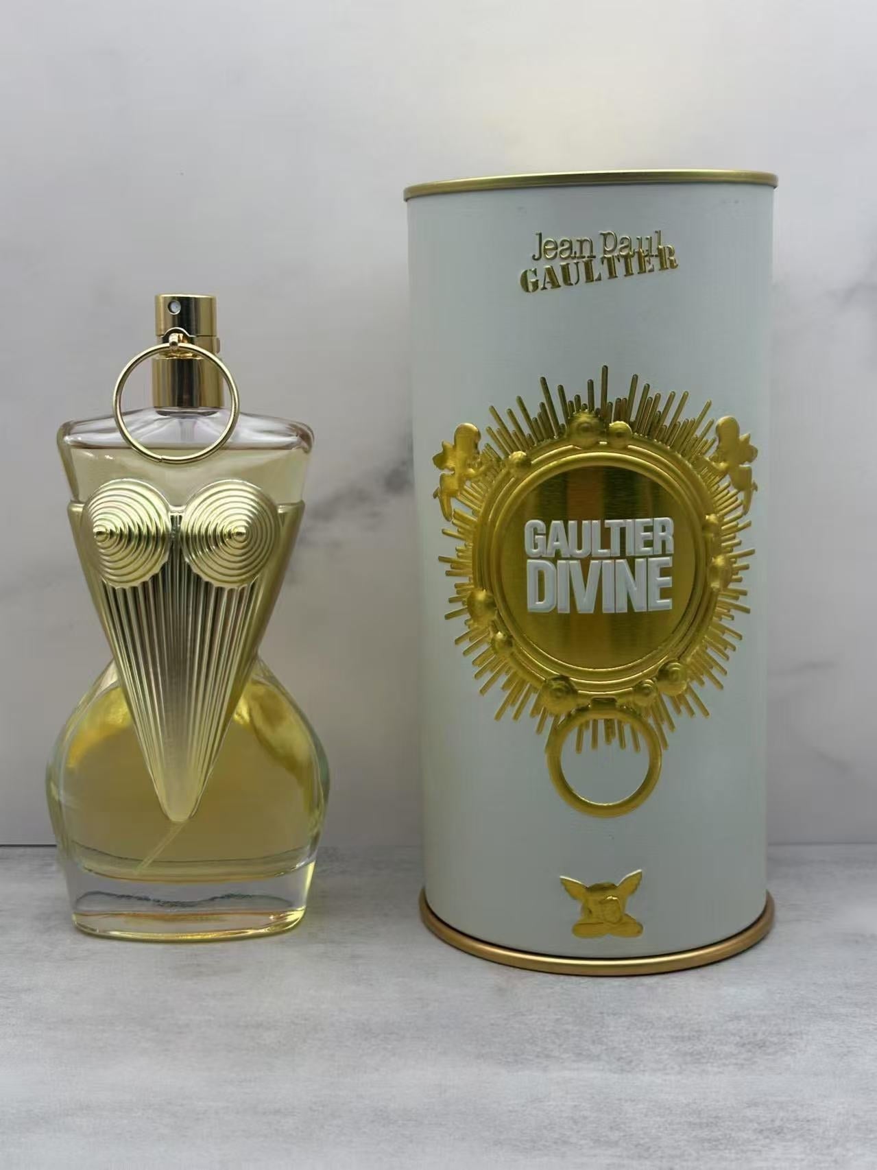 Perfume bottle and packaging of Jean Paul Gaultier Gaultier Divine on a light background