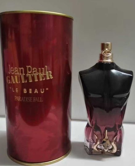 Jean Paul Gaultier perfume bottle and red cylindrical container on a white background