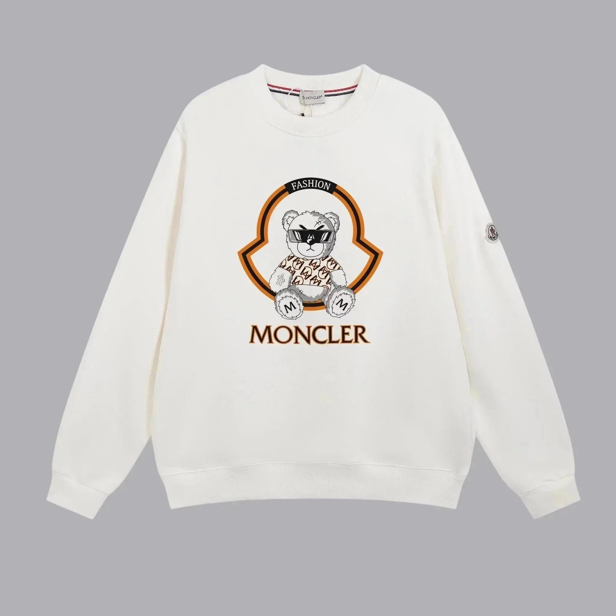 White sweatshirt with a logo and 'Moncler' text on a gray background
