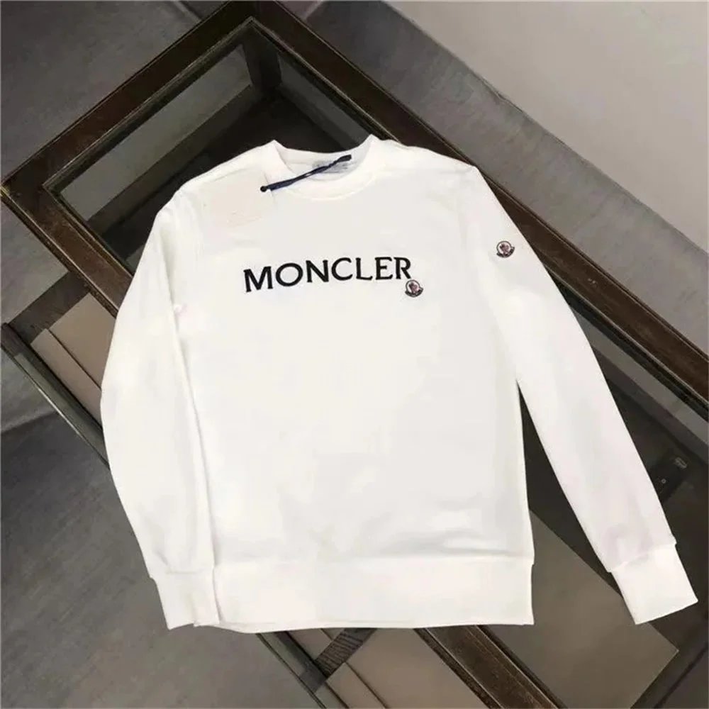 White Moncler sweatshirt on a reflective surface