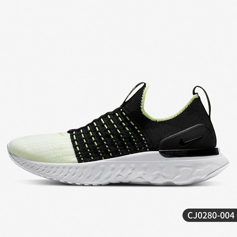 Black and white sneaker with green accents on a light gray background