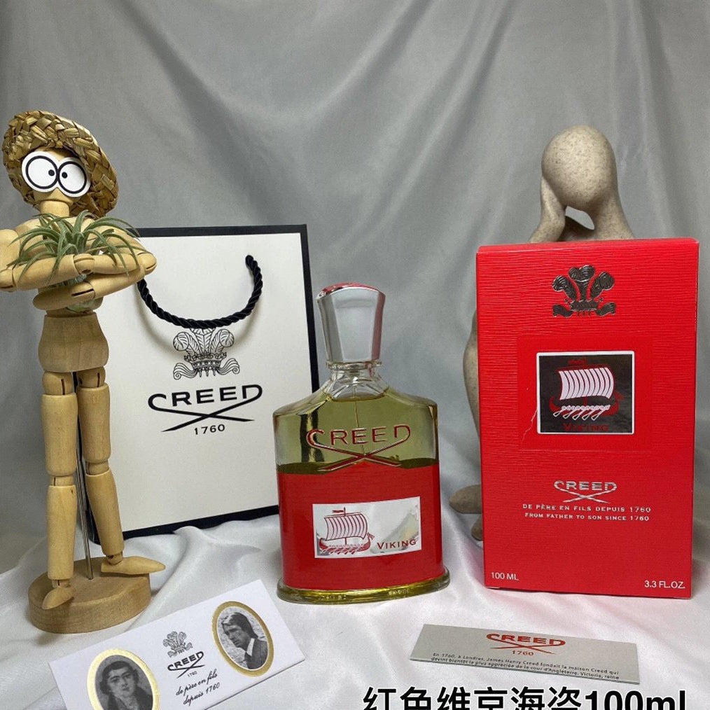 Creed perfume bottle and packaging on a gray background