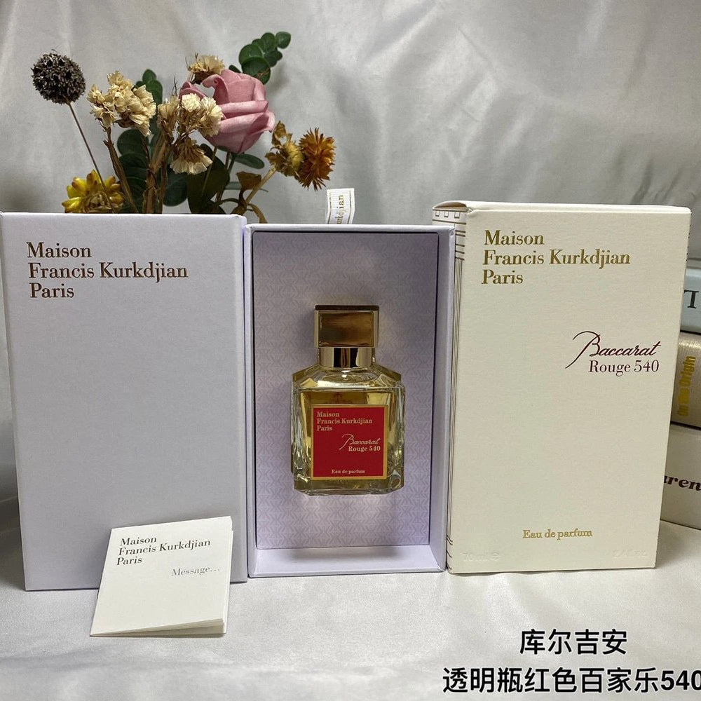 Maison Francis Kurkdjian perfume bottle in a box with flowers on a light gray background