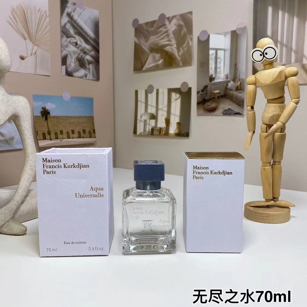 Maison Francis Kurkdjian perfume bottle and packaging on a table with decorative items.