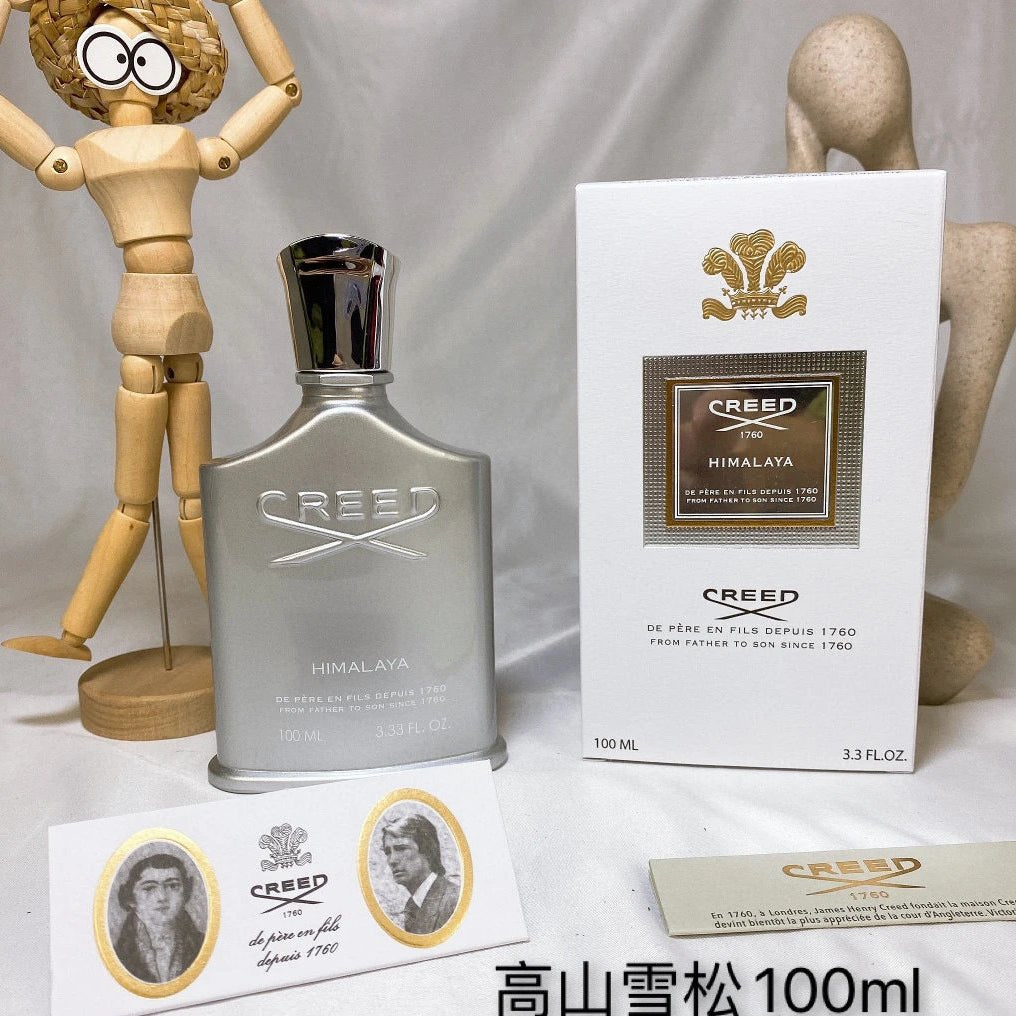 Creed Himalaya perfume bottle with packaging and wooden figure on a white background