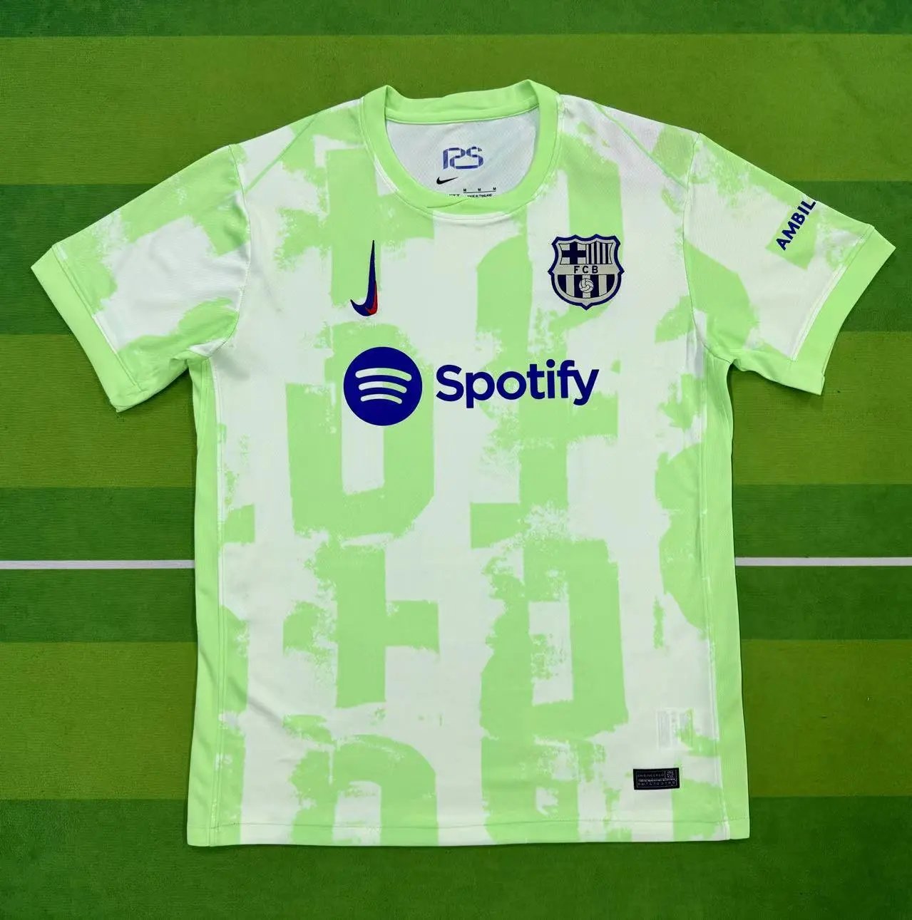Green and white sports jersey with Nike and Spotify logos on a green background