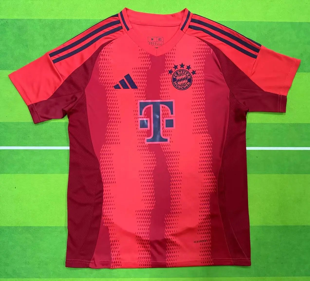 Red sports jersey with blue logo on a green background