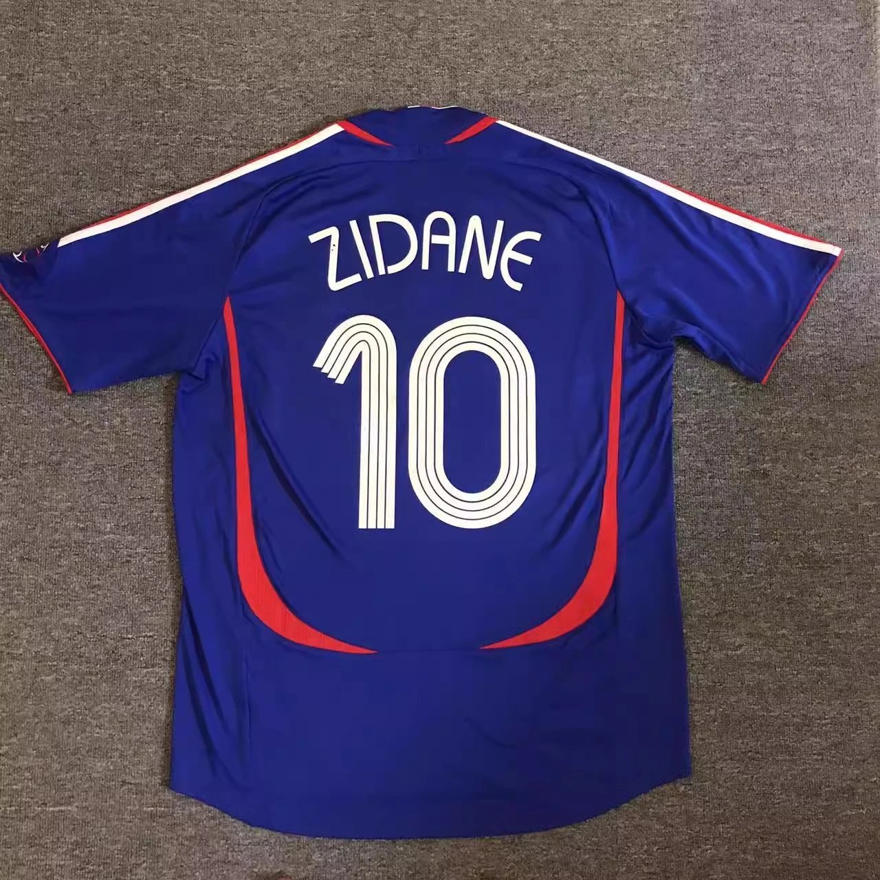 Blue sports jersey with 'Zidane' and number '10' on a gray background