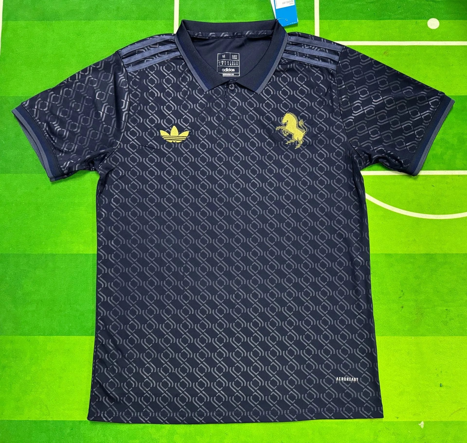 Navy blue sports jersey with yellow logo on a green background
