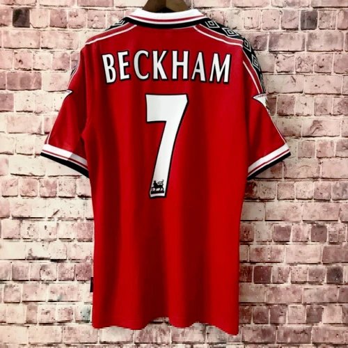 Red sports jersey with 'Beckham' and number '7' on a brick wall background