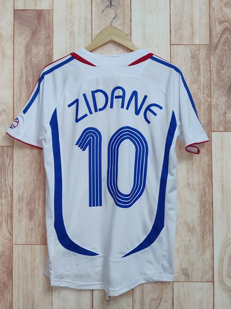 White sports jersey with 'Zidane' and number '10' on a wooden background
