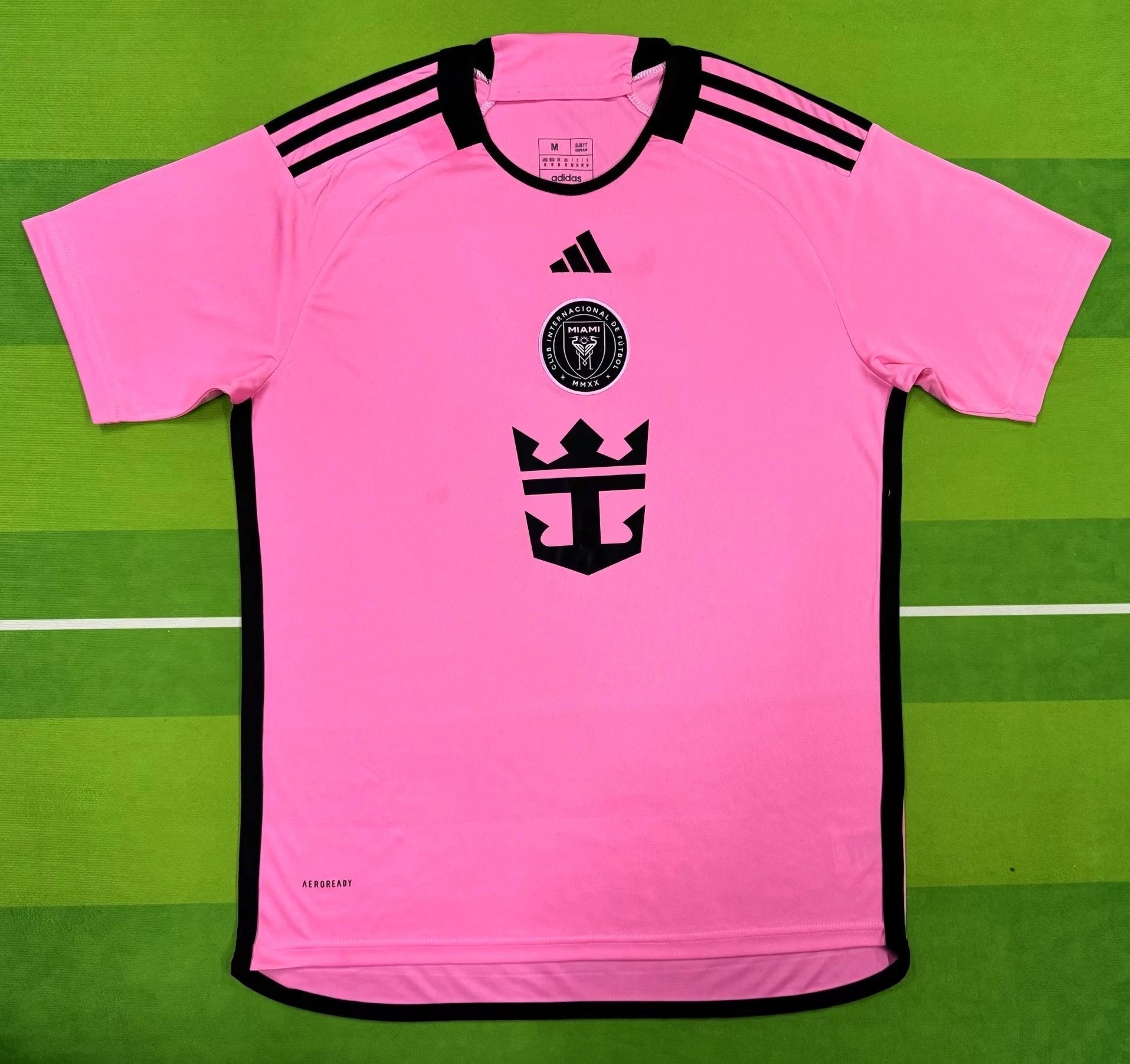Pink sports jersey with black accents on a green background