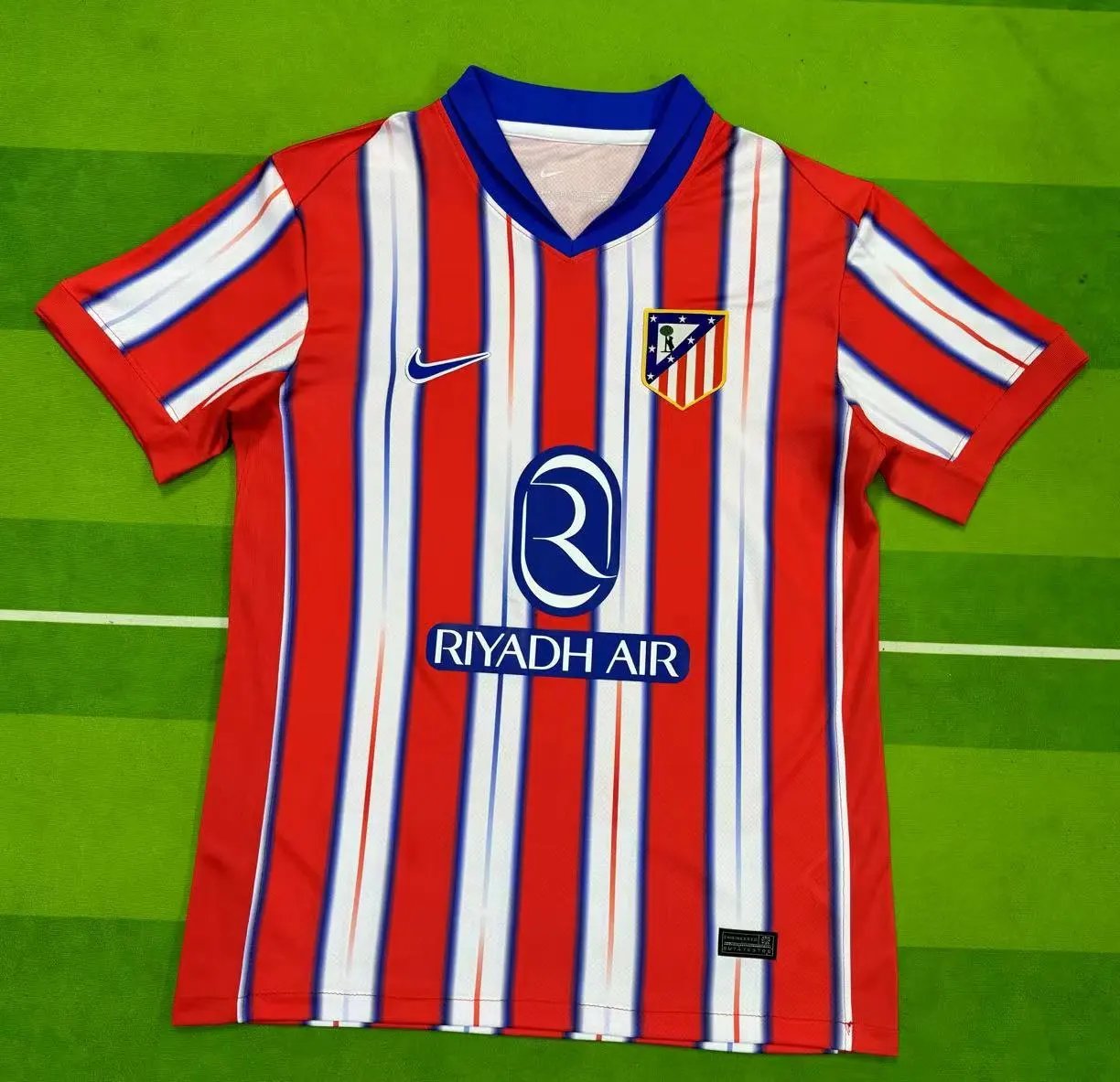 Red and white striped sports jersey with visible branding on a green background