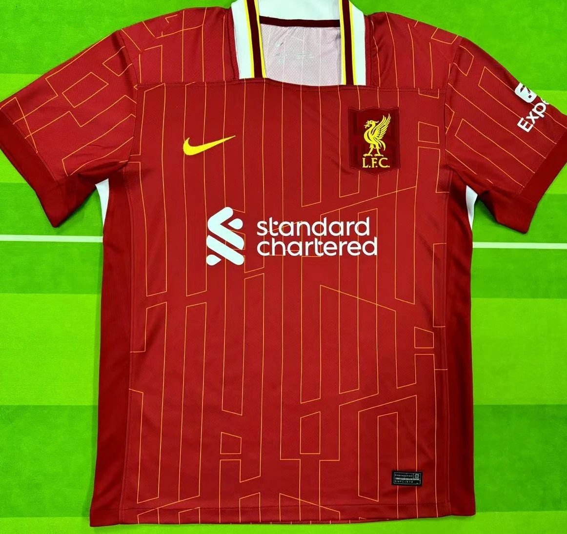Red sports jersey with branding on a green background