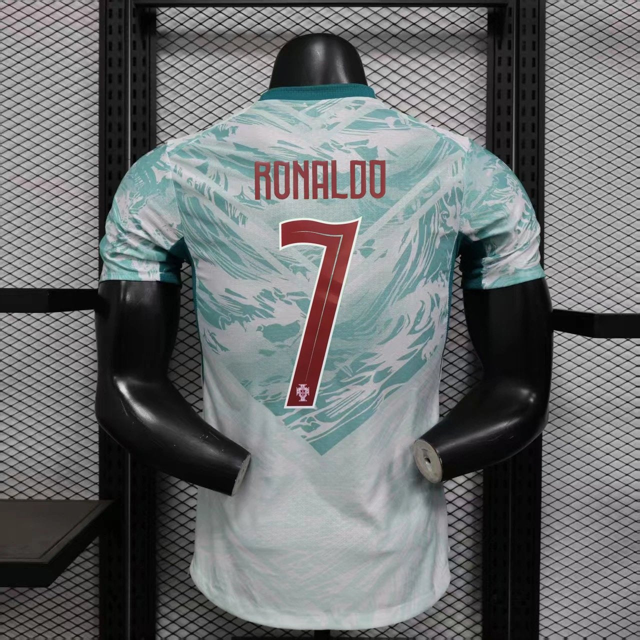 Soccer jersey with 'RONALDO' and number '7' on a mannequin against a grid background