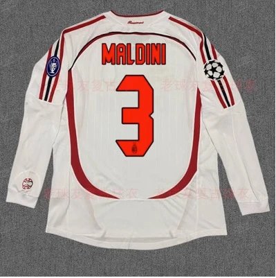 White soccer jersey with red numbering and text on a gray background