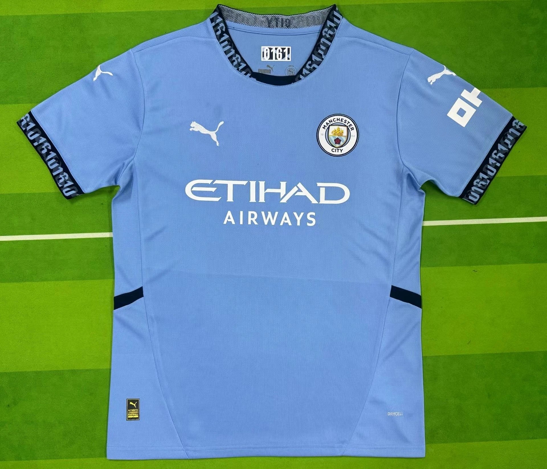 Light blue sports jersey with branding on a green background