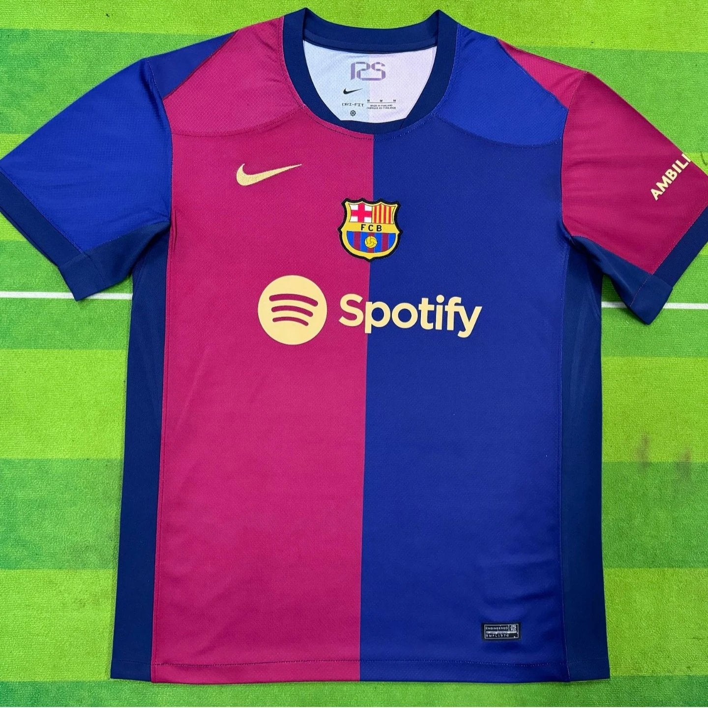 Soccer jersey with Nike and Spotify logos on a green field background