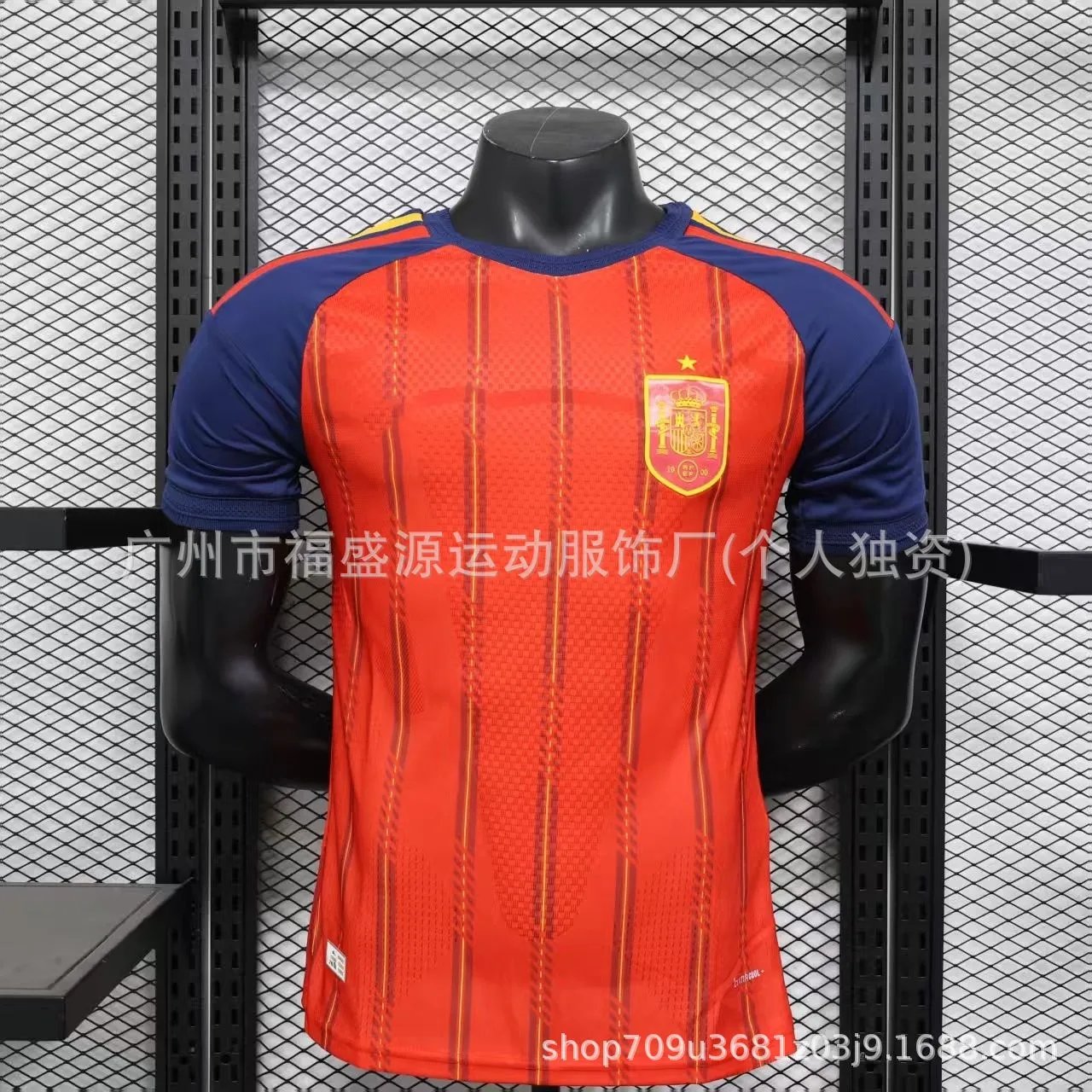 Orange sports jersey with blue sleeves on a mannequin against a black mesh background
