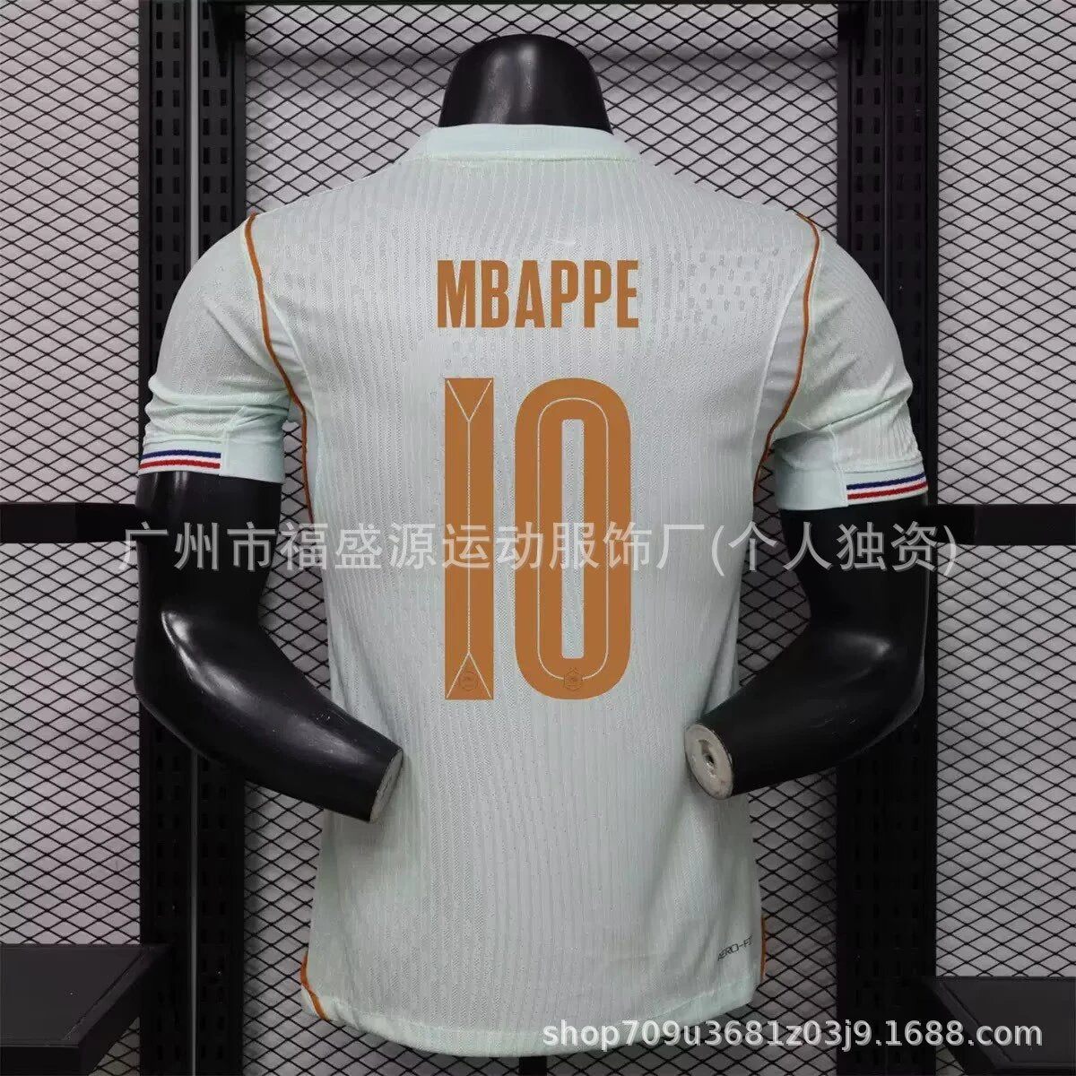 White sports jersey with 'MBAPPE 10' printed on it, displayed on a mannequin against a grid background.