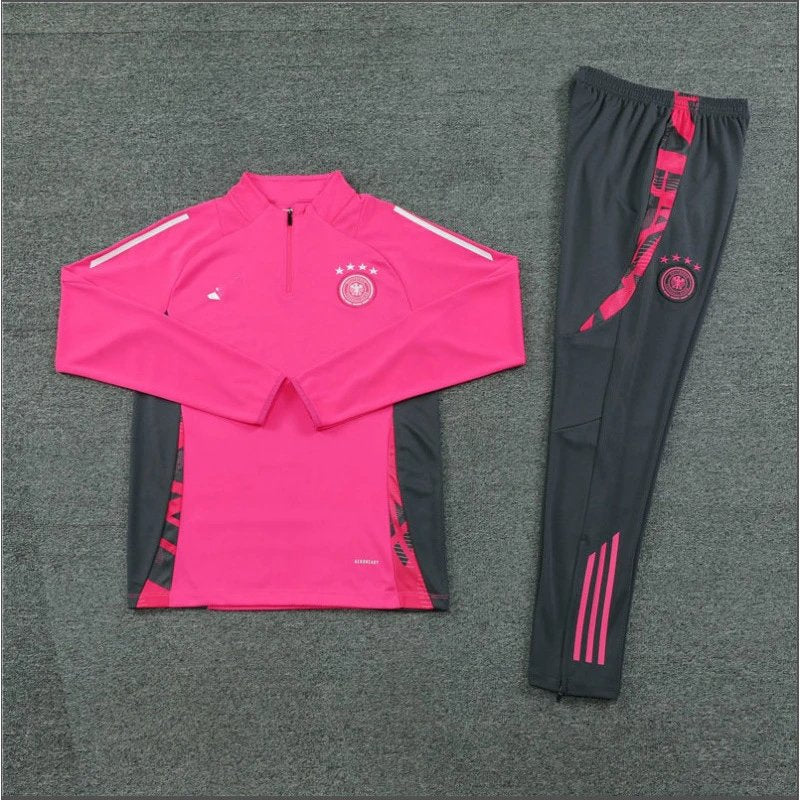 Pink and black tracksuit with visible branding on a gray background