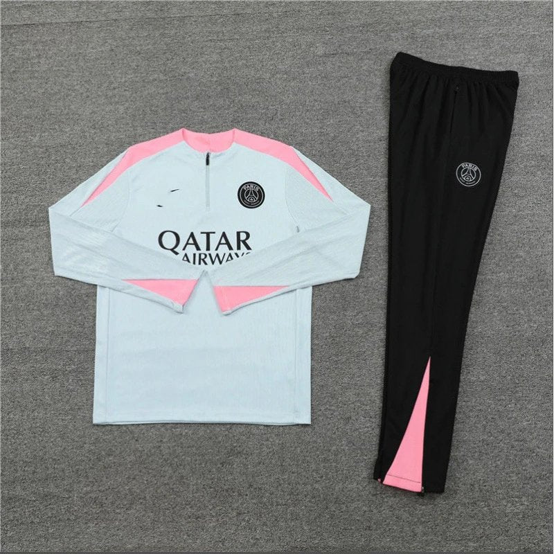 Light blue and pink sports jacket with black pants on a gray background