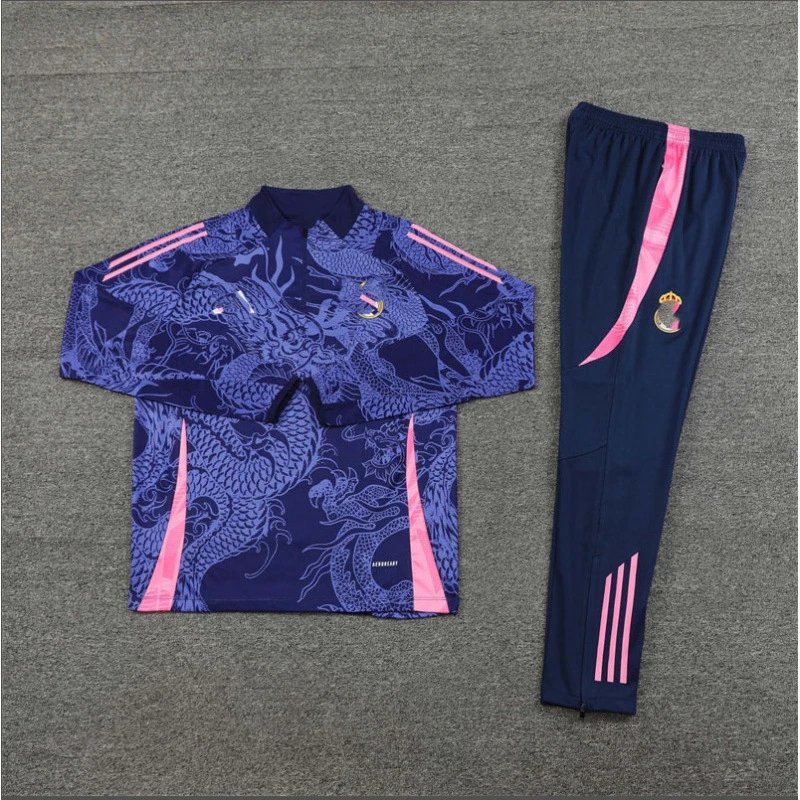Navy tracksuit with dragon design and pink accents on a gray background
