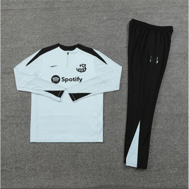 White and black tracksuit with Spotify logo on a gray background