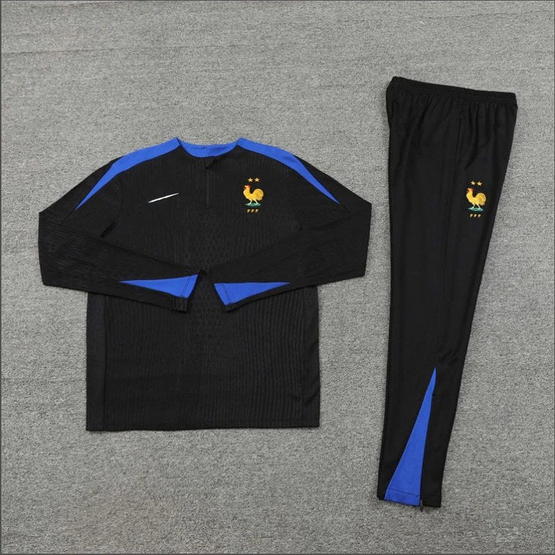 Black tracksuit with blue accents on a gray surface