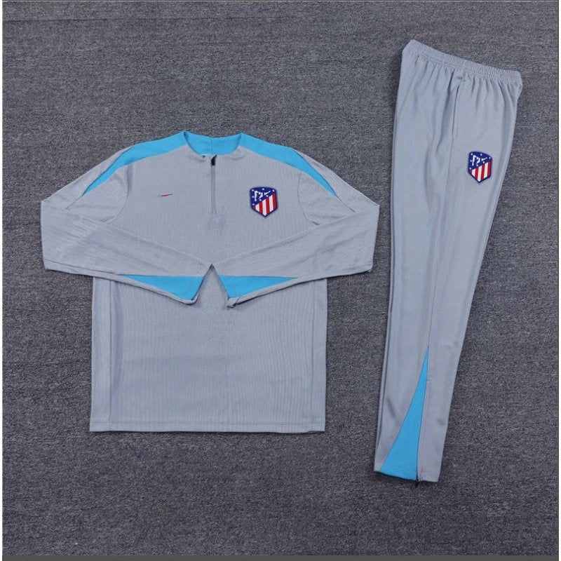 Gray tracksuit with blue accents and a logo on a gray background