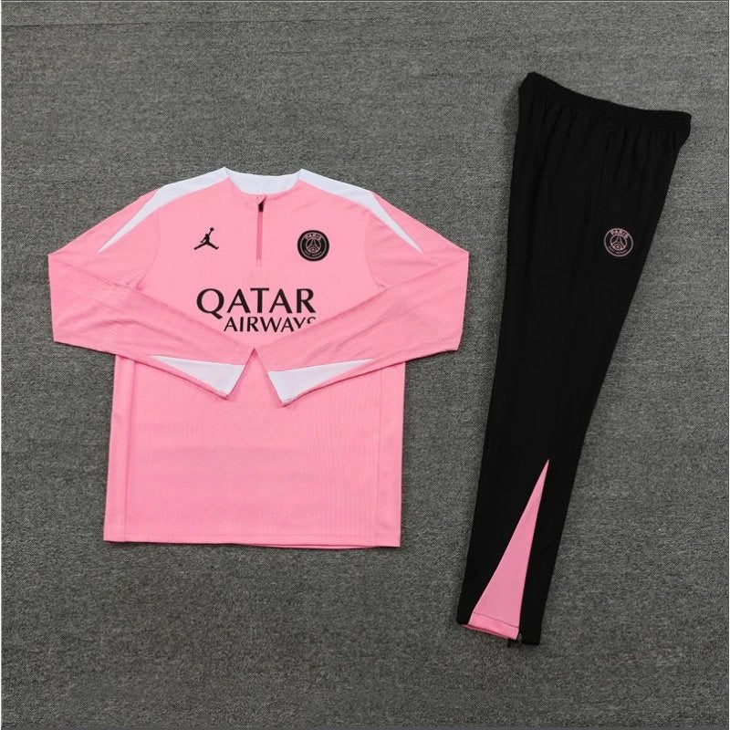 Pink sports outfit with black pants on a gray background