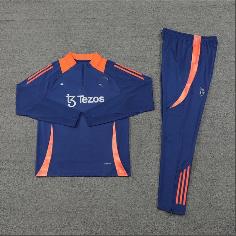 Blue tracksuit with orange accents and 'Tezos' branding on a gray background