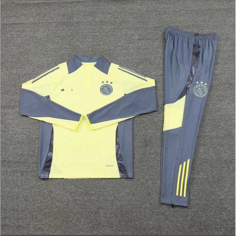 Yellow and gray sports tracksuit with a logo on a gray background