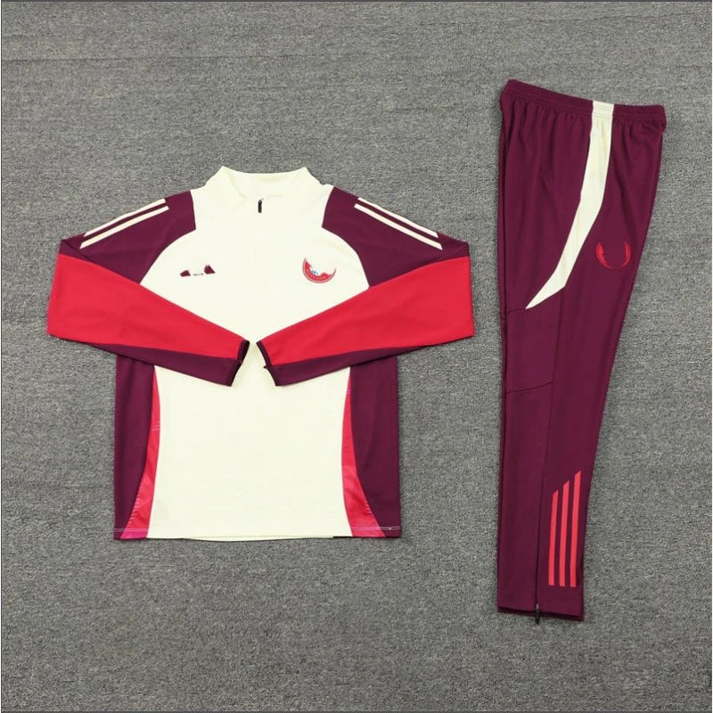 Maroon and red tracksuit with white accents on a gray background